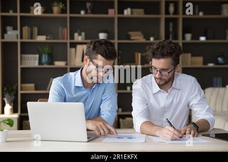 Serious family business partners collaborating on startup together Stock Photo