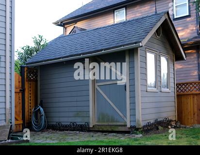 tool shed Garden and Tool Shed in Yard Near Flowers and Grass. High quality photo Stock Photo