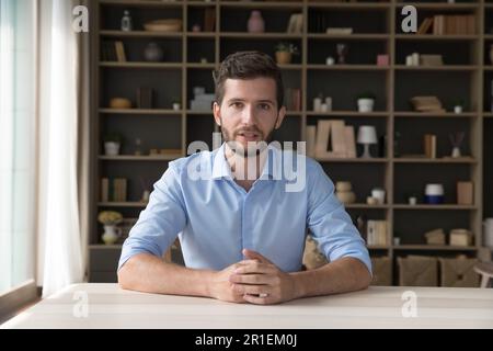 Serious handsome young online teacher man giving webinar Stock Photo