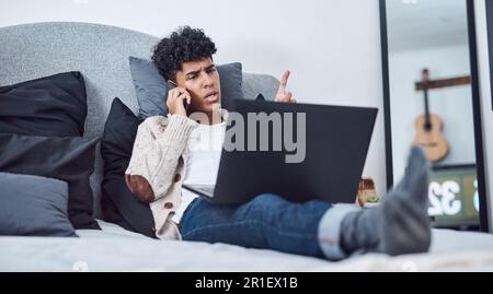 When the bedroom becomes a boardroom. a young man using a smartphone and laptop on the bed at home. Stock Photo