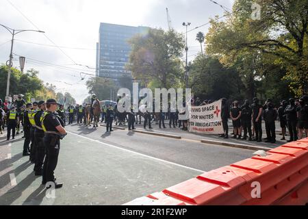 Melbourne, Australia, 13 May, 2023. Police surround Nazi protesters during a heated political rally against racism, as far-right neo-Nazi groups held a demonstration at state parliament, leading to clashes and scuffles on May 13, 2023 in Melbourne, Australia. Credit: Michael Currie/Speed Media/Alamy Live News Stock Photo