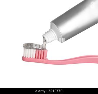 Applying charcoal toothpaste on brush against white background Stock Photo