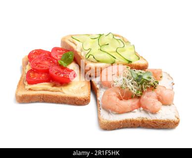 Delicious toasts with different toppings isolated on white Stock Photo