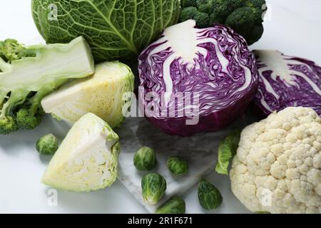 Many different types of cabbage on white table Stock Photo