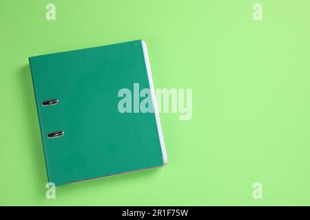 Office folder on light green background, top view Stock Photo