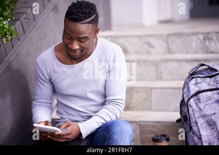 Relax, college and tablet with black man on stairs for learning, education or research. School, social media and technology with male student on steps Stock Photo