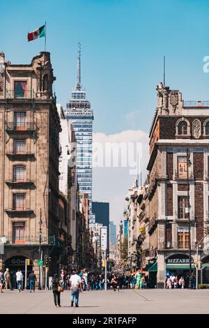 wonky sunken colonial buildings line Madero Street, a pedestrian mall off Mexico City's main square. Torre Latinoamericana can be seen behind Stock Photo