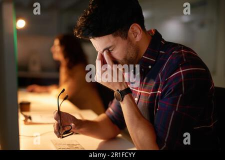 Stress, headache and burnout with a man programmer working on a computer in his office for design. Tired, 404 and deadline with a male employee Stock Photo