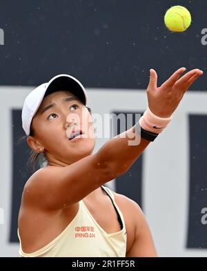 Rome, Italy. 13th May, 2023. Wang Xiyu of China serves during the round of 32 match between Wang Xiyu of China and Taylor Townsend of the United States at the WTA Italian Open in Rome, Italy, May 13, 2023. Credit: Alberto Lingria/Xinhua/Alamy Live News Stock Photo