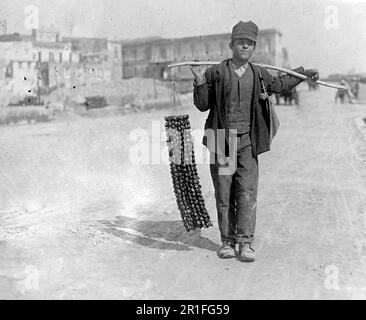 Archival Photo: Young chestnut vendor in Naples Italy ca. 1908-1919 Stock Photo