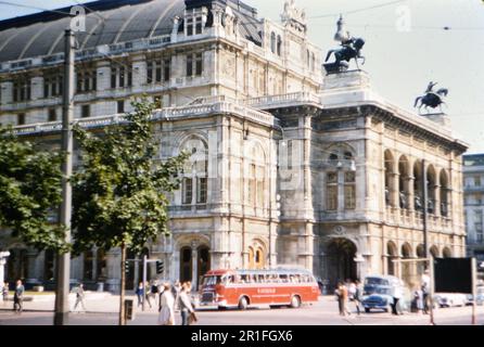 A bus and pedestrian traffic in front of the Vienna Opera House in Vienna Austira ca. 1960 Stock Photo