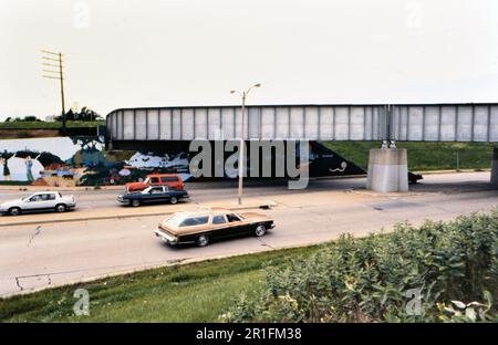 Cars driving toward and away from an underpass / overpass ca. 1987 Stock Photo