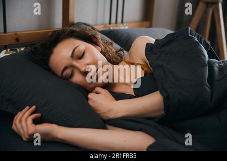 Serene sleeping woman sleeping in an orthopedic bed Stock Photo