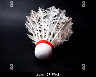 Picture of a broken shuttlecock on a black isolated background Stock Photo