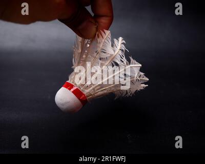 Picture of a broken shuttlecock on a black isolated background Stock Photo