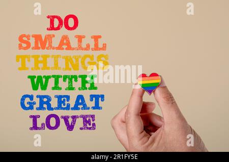 Do Small Things With Great Love. Rainbow colored heart and text on a light background. Stock Photo