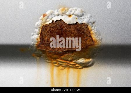 A rust spot on the car. Peeled paint. Stock Photo