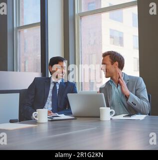 Developing their ideas together. businessmen working in their office. Stock Photo