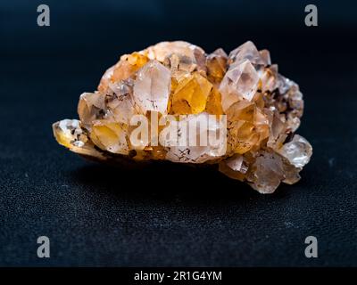 Picture of a yellow quartz citrine cluster crtystal on a black background Stock Photo