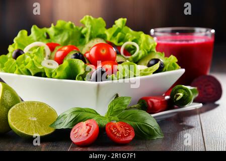 Composition with vegetable salad bowl and glass of juice. Balanced diet Stock Photo