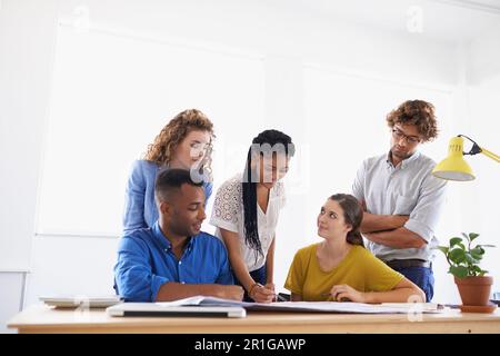 Diversity, business people and writing in team project, planning or strategy together at office. Group of diverse employees working on paperwork Stock Photo