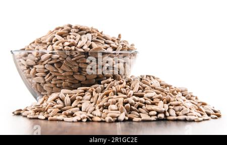 Bowl of shelled sunflower seeds isolated on white background Stock Photo