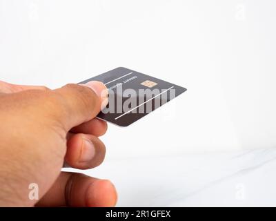 Picture of a black warranty card hold by asian man hand Stock Photo