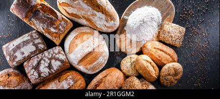 Assorted bakery products including loafs of bread and rolls Stock Photo