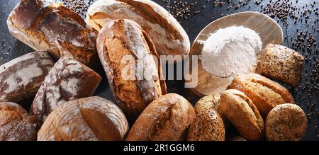 Assorted bakery products including loafs of bread and rolls Stock Photo