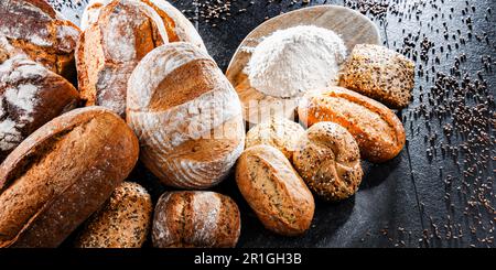 Assorted bakery products including loafs of bread and rolls Stock Photo