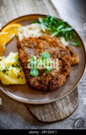 Pork breaded cutlet coated with breadcrumbs with mashed potatoes and cabbage Stock Photo