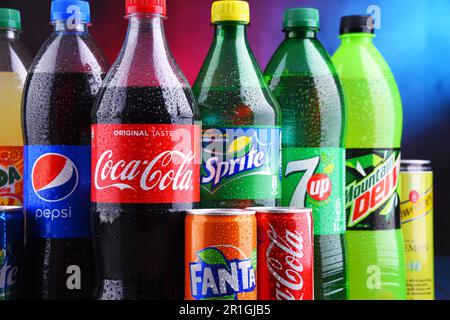 POZNAN, POLAND - NOV 16, 2018: Bottles and cans of global soft drink brands including products of Coca Cola Company and Pepsico Stock Photo