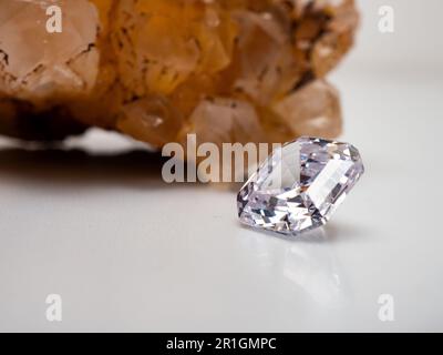 Side view of a sparkling asscher cut diamond with rough stone background Stock Photo