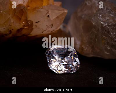 Sparkling asscher cut diamond with rough crystal as background Stock Photo
