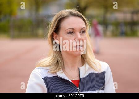 Burnt out attractive middle aged blond woman outdoors looking thoughtfully into distance Stock Photo