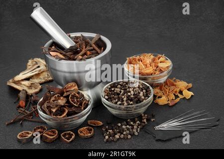 Chinese acupuncture treatment with needles, herbs, spice. Natural plant medicine remedy for alternative health care concept. Stock Photo