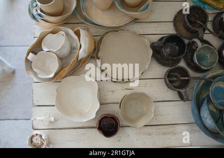 finished pottery in glaze on the table. Stock Photo