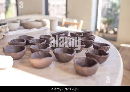 clay plates on the table, raw texture. Stock Photo