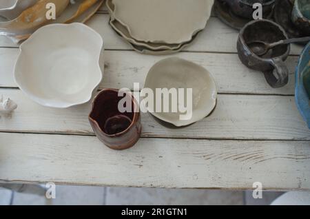 finished pottery in glaze on the table. Stock Photo