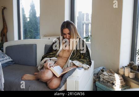 The girl pours Hot black coffee into handmade clay mugs. Stock Photo