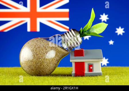 Plant growing inside the light bulb, miniature house on the grass and Australia Flag. Renewable energy. Electricity prices, energy saving in the house Stock Photo
