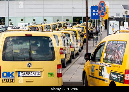 Yellow taxi cabs waiting for fare at the Sofia Airport Terminal 2 taxi rank, Sofia, Bulgaria, Eastern Europe, Balkans, EU Stock Photo