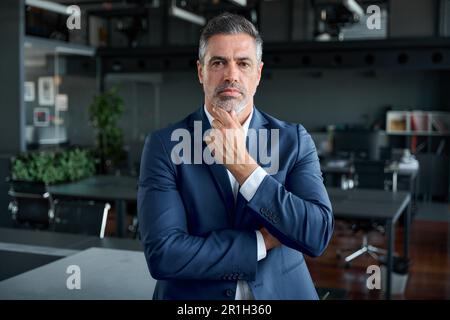 Serious confident middle aged business man wearing suit thinking in office. Stock Photo