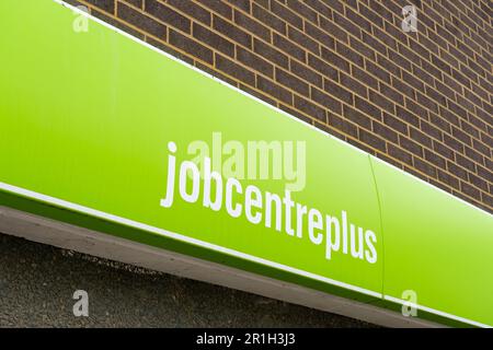 Sign on the Jobcentre Plus building on Winchester Road in Basingstoke, Hampshire, England. Copy space. Concept: DWP, unemployment rate, out of work Stock Photo