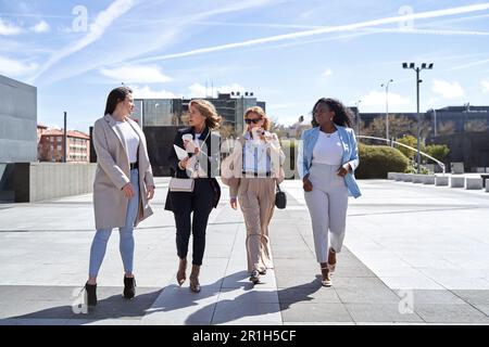Professional and Confident Female Entrepreneurs Having a Productive Discussion While Strolling Through the Financial District, Symbolizing Success and Empowerment Stock Photo