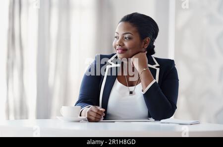 The ideas are always there. an attractive young businesswoman looking thoughtful while sitting behind her desk in the office. Stock Photo