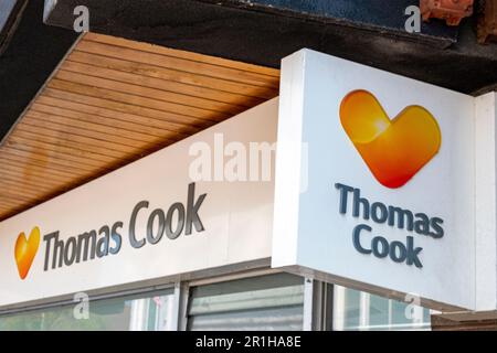 Thomas Cook travel agent shop sign on outside wall UK Stock Photo