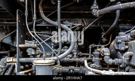 Grunge vintage weathered, steampunk mechanical background with pipes, valves, and steam fittings Stock Photo