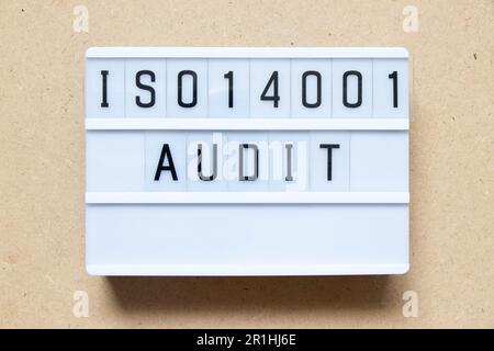 Lightbox with word ISO 14001 audit on wood background Stock Photo