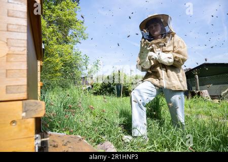 Wiesbaden, Germany. 04th May, 2023. Beekeeper Lilian Hurth stands in front of a hive where bees are flying. (to dpa-Korr 'Younger and more female': Beekeeping is changing') Credit: Sebastian Gollnow/dpa/Alamy Live News Stock Photo